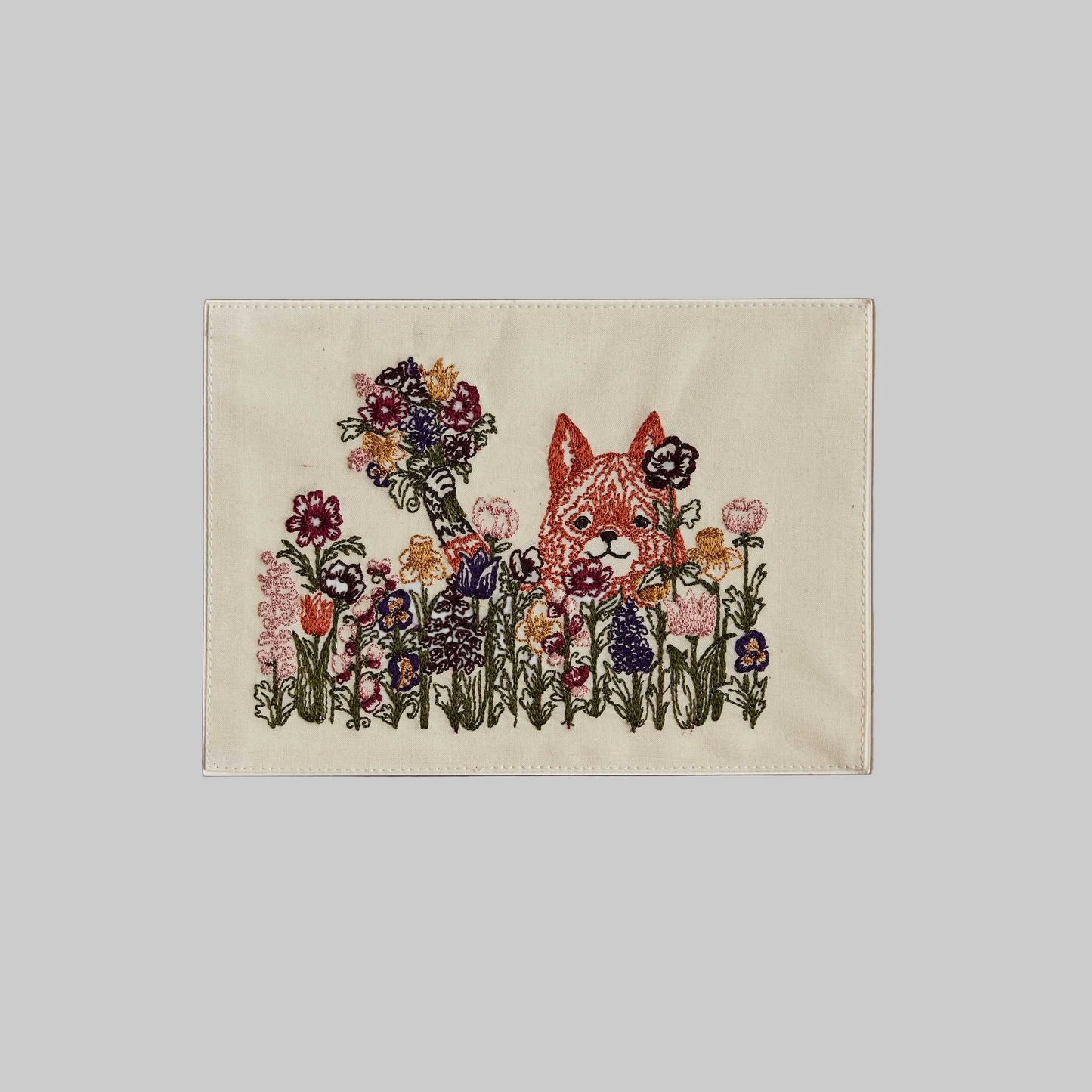 Coral and Tusk's "Bunch of Love" embroidered keepsake card  featuring a fox in a field of flowers holding a bouquet 