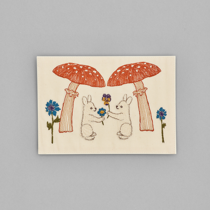 Coral and Tusk's "Mushroom Bunny Friends" embroidered keepsake card  featuring two bunnies and mushrooms