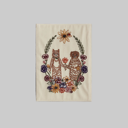 Coral and Tusk's "Cat and Dog Friends" embroidered keepsake card  featuring a cat and dog surrounded by a wreath of flowers