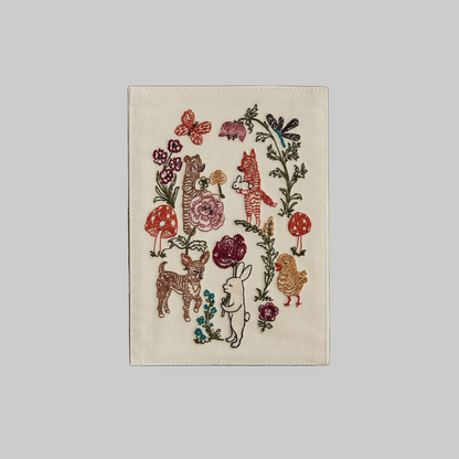 Coral and Tusk's "Sailboat" embroidered keepsake card  featuring animals surrounded by botanical designs