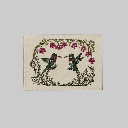 Coral and Tusk's "Hummingbird Hearts" embroidered keepsake card  featuring two hummingbirds with florals 