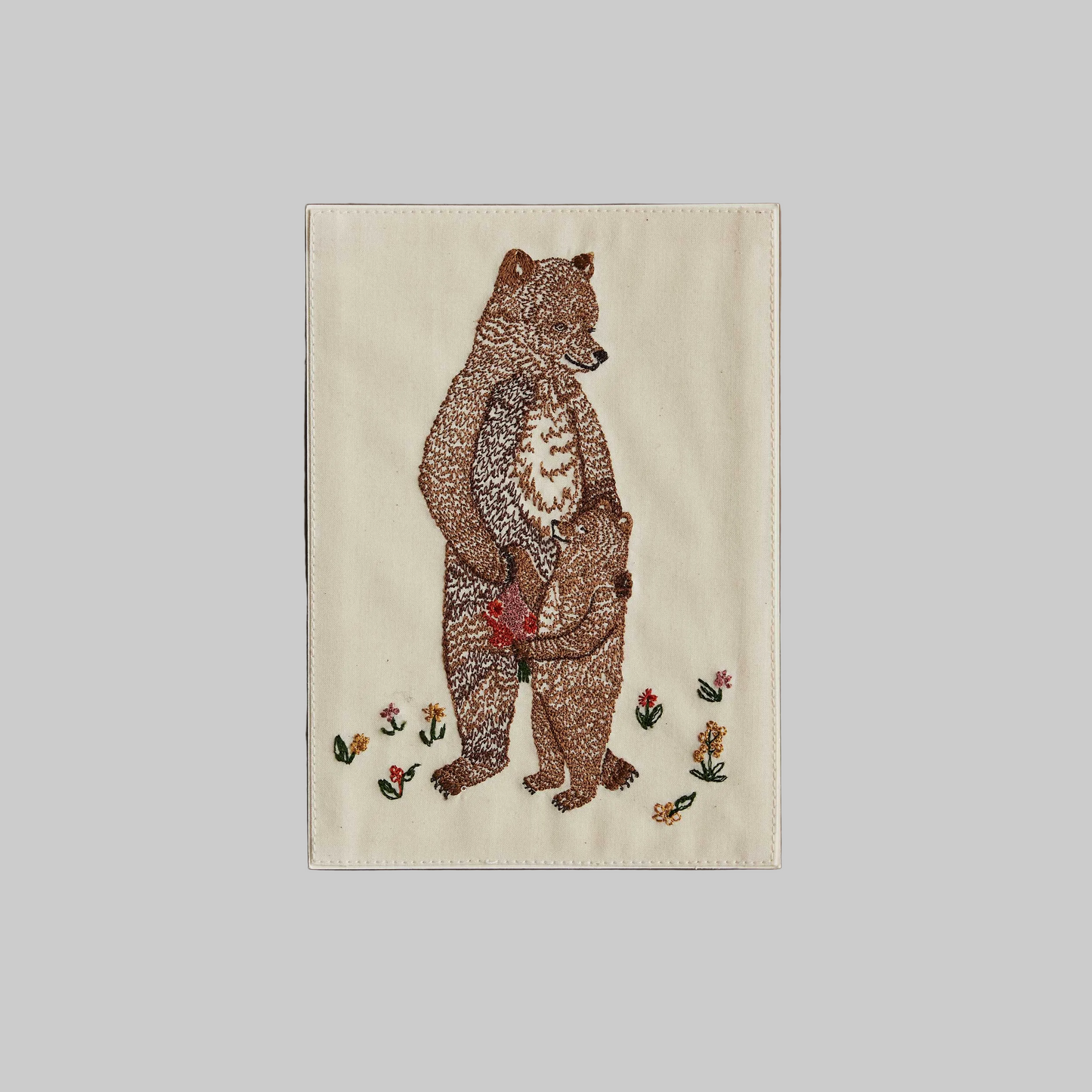 Coral and Tusk's "Mama Bear and Cub" embroidered keepsake card  featuring a mother and baby bear hugging with flowers