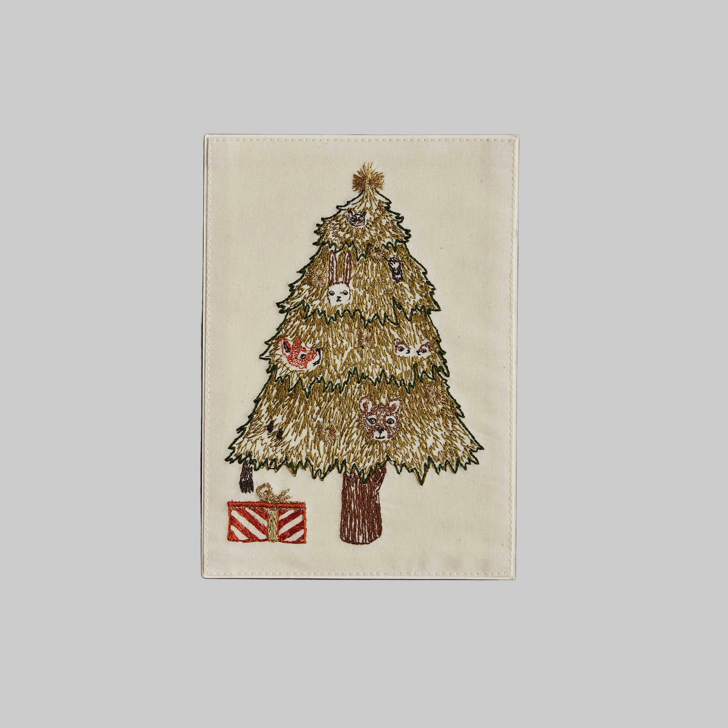 Coral and Tusk's "Peek a Tree" embroidered keepsake card  featuring a Christmas tree with animals peeking out