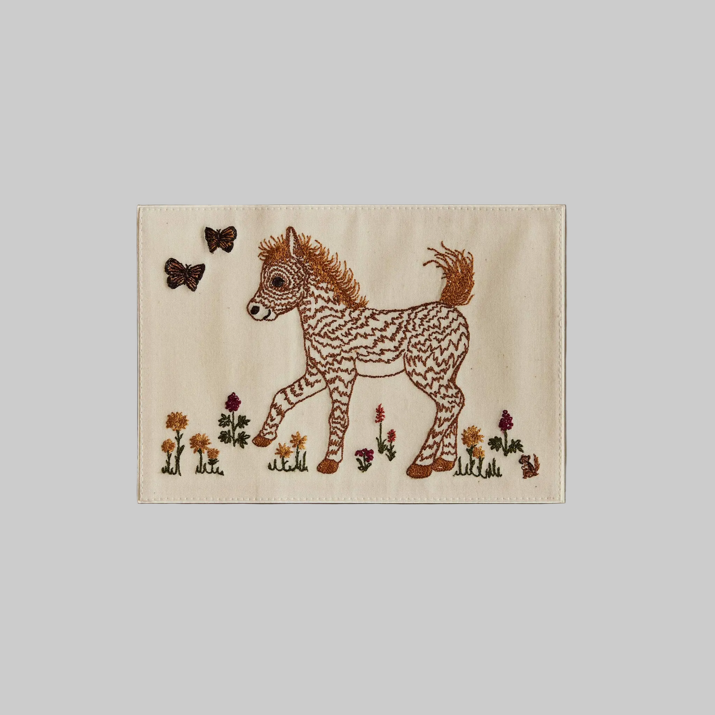 Coral and Tusk's "Prancing Pony" embroidered keepsake card  featuring a small horse and two butterflies