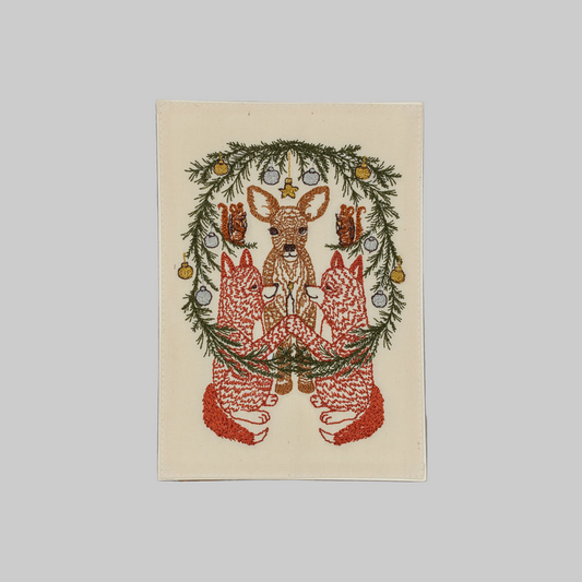 Coral and Tusk's "Togetherness" embroidered keepsake card  featuring foxes, chipmunks, and a deer surrounded by a holiday wreath