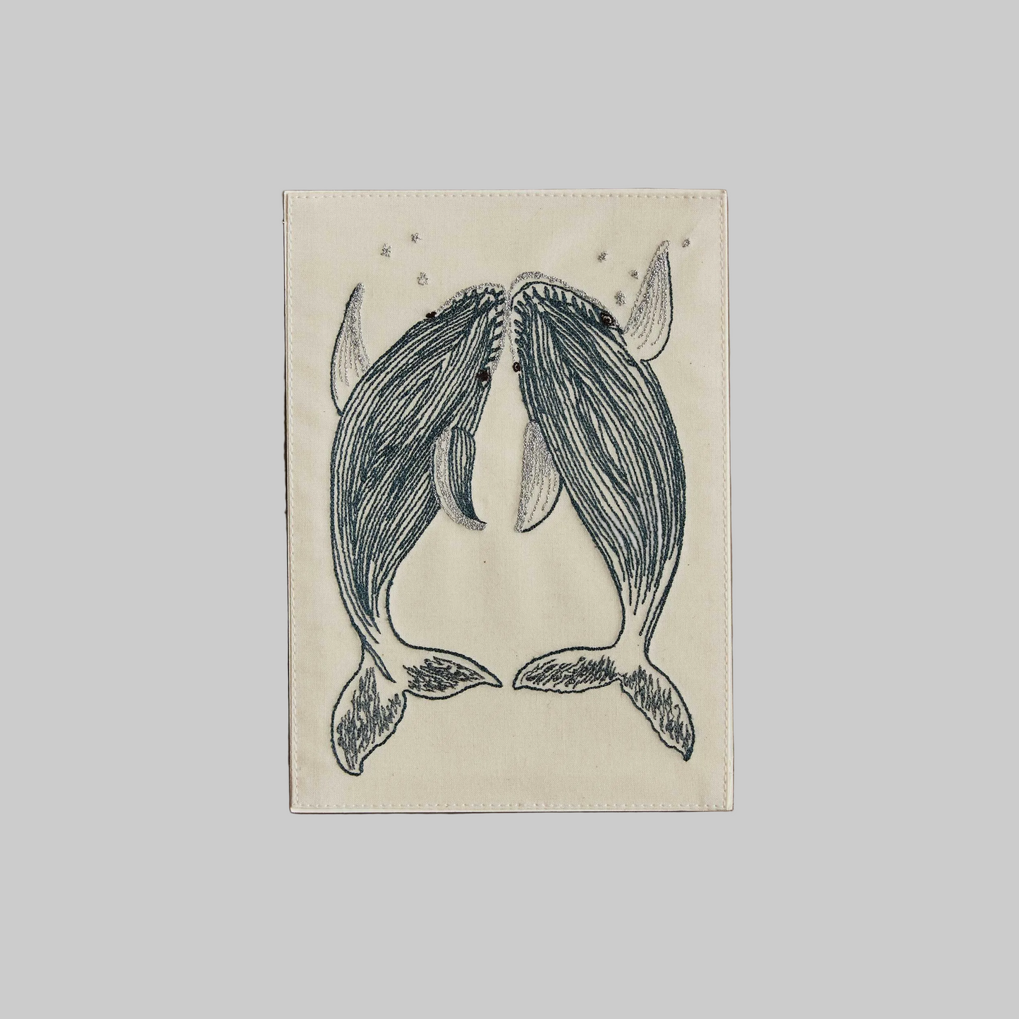 Coral and Tusk's "Humpback Whales" embroidered keepsake card  featuring two whales swimming upward