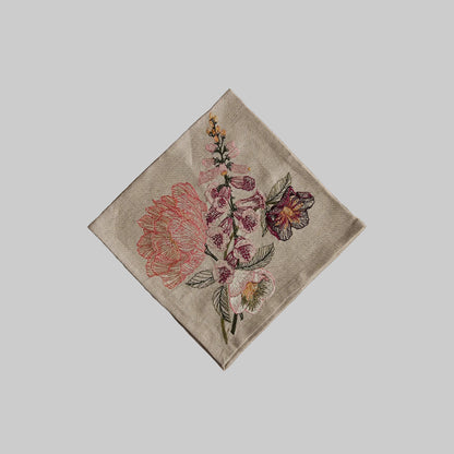 Coral and Tusk’s “Blush Bouquet” embroidered linen dinner napkin featuring vibrant florals in shades of pink and maroon