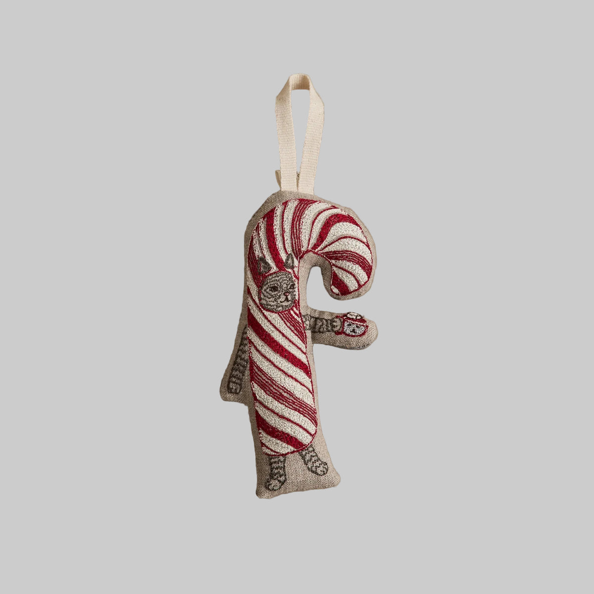 Coral and Tusk's "Candy Cane Cat" embroidered linen Christmas ornament featuring design of a gray tabby cat dressed as a candy cane