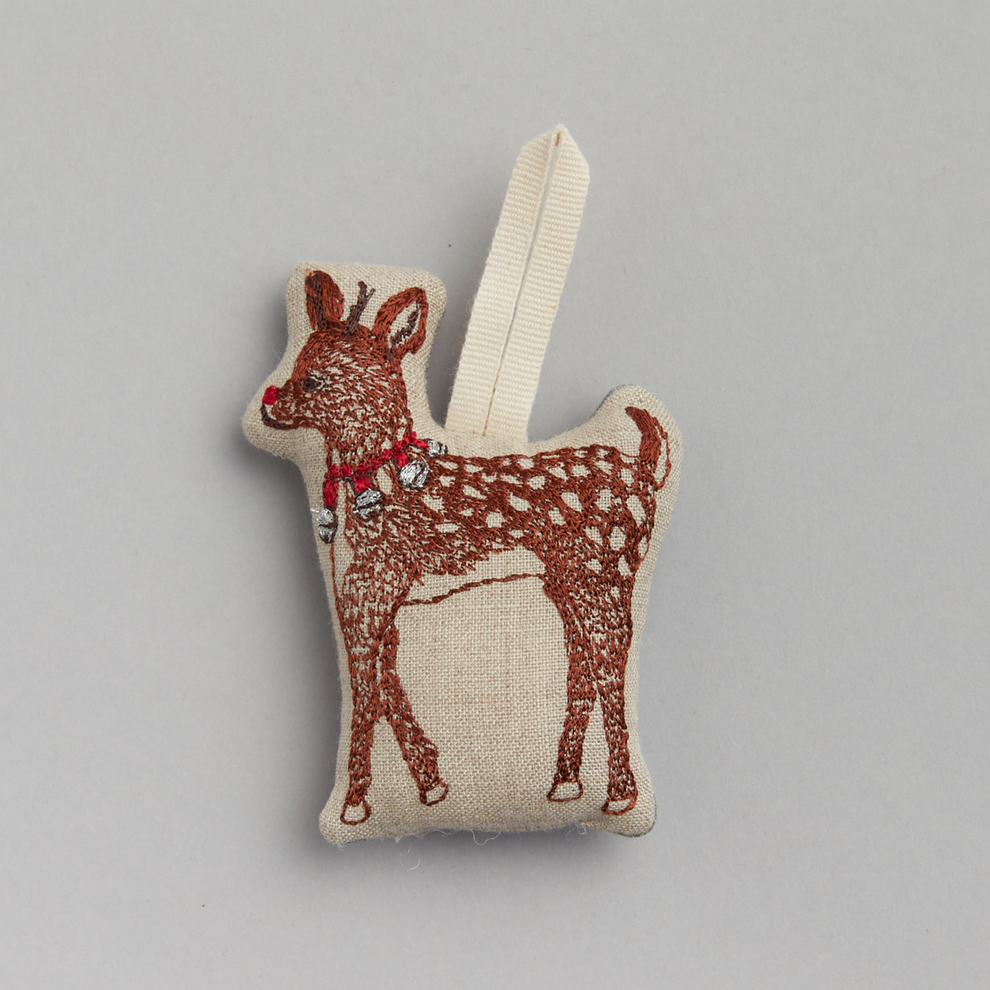 Coral and Tusk's "Rudolph" embroidered linen Christmas ornament featuring design of a young reindeer wearing a necklace of bells