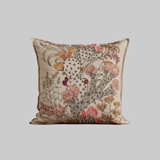 Coral and Tusk’s “Desert Blooms” embroidered linen pillow featuring vibrant colors of flowering cactus and blossoming agave, measures 20” x 20”