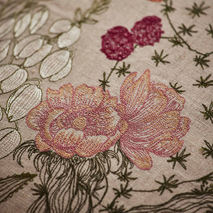 Coral and Tusk’s “Desert Blooms” embroidered linen pillow featuring vibrant colors of flowering cactus and blossoming agave, measures 20” x 20”
