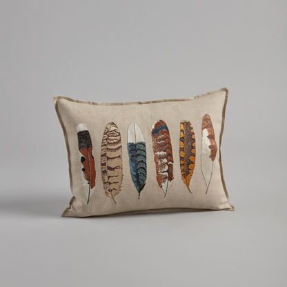 Coral and Tusk’s “Medium Feathers” embroidered linen pillow featuring a variety of bird feathers, measures 12” x 16”