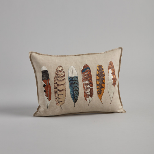 Coral and Tusk’s “Medium Feathers” embroidered linen pillow featuring a variety of bird feathers, measures 12” x 16”