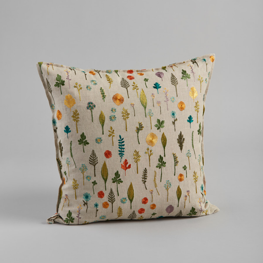 Coral and Tusk's "Garden Pattern" embroidered linen pillow featuring a field of dandy flowers, forget-me-nots, violets and sprigs, measures 20" x 20"