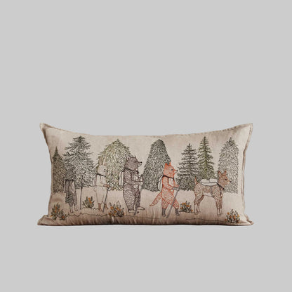 Coral and Tusk’s “Hikers” embroidered linen pillow featuring woodland friends trekking through the wilderness, measures 14” x 26”