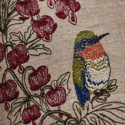 Coral and Tusk’s “Hummingbird Hearts” pillow embroidered with two hummingbirds and bleeding heart flowers, measures 12” x 12” 