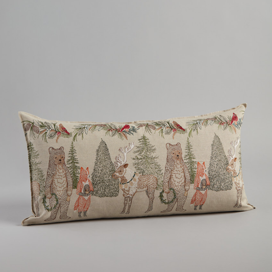 Coral and Tusk's "Christmas Cheer" embroidered linen lumbar pillow featuring festive woodland animals in an evergreen forest, measures 16" x 32" 