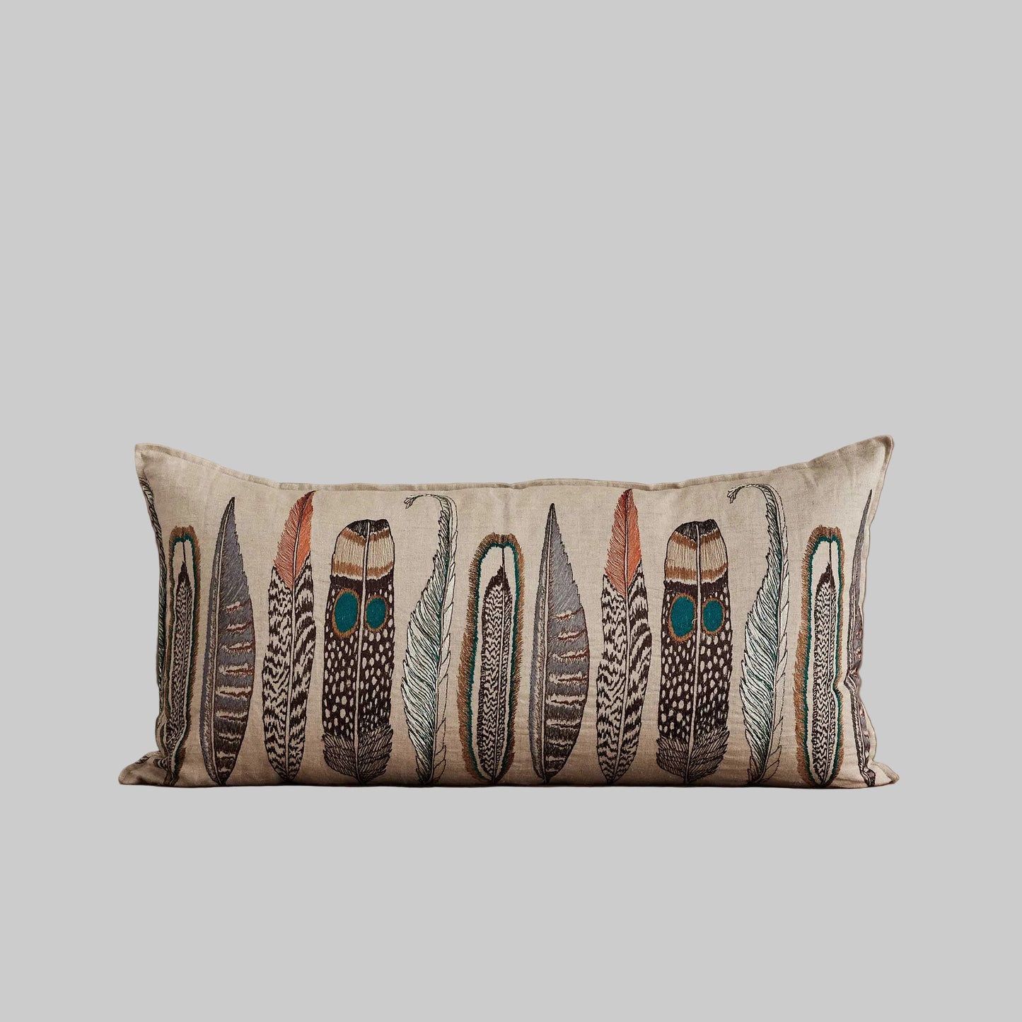 Coral and Tusk’s “Large Feathers” embroidered linen lumbar pillow featuring an array of feathers from birds of prey: hawk, eagle, falcon, and owl, measures 16” x 32”