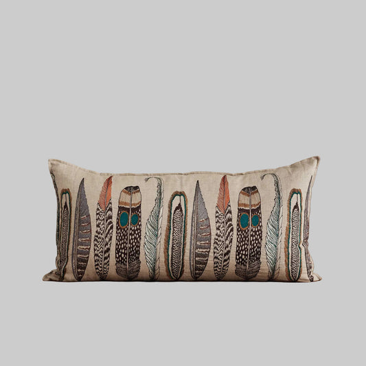 Coral and Tusk’s “Large Feathers” embroidered linen lumbar pillow featuring an array of feathers from birds of prey: hawk, eagle, falcon, and owl, measures 16” x 32”