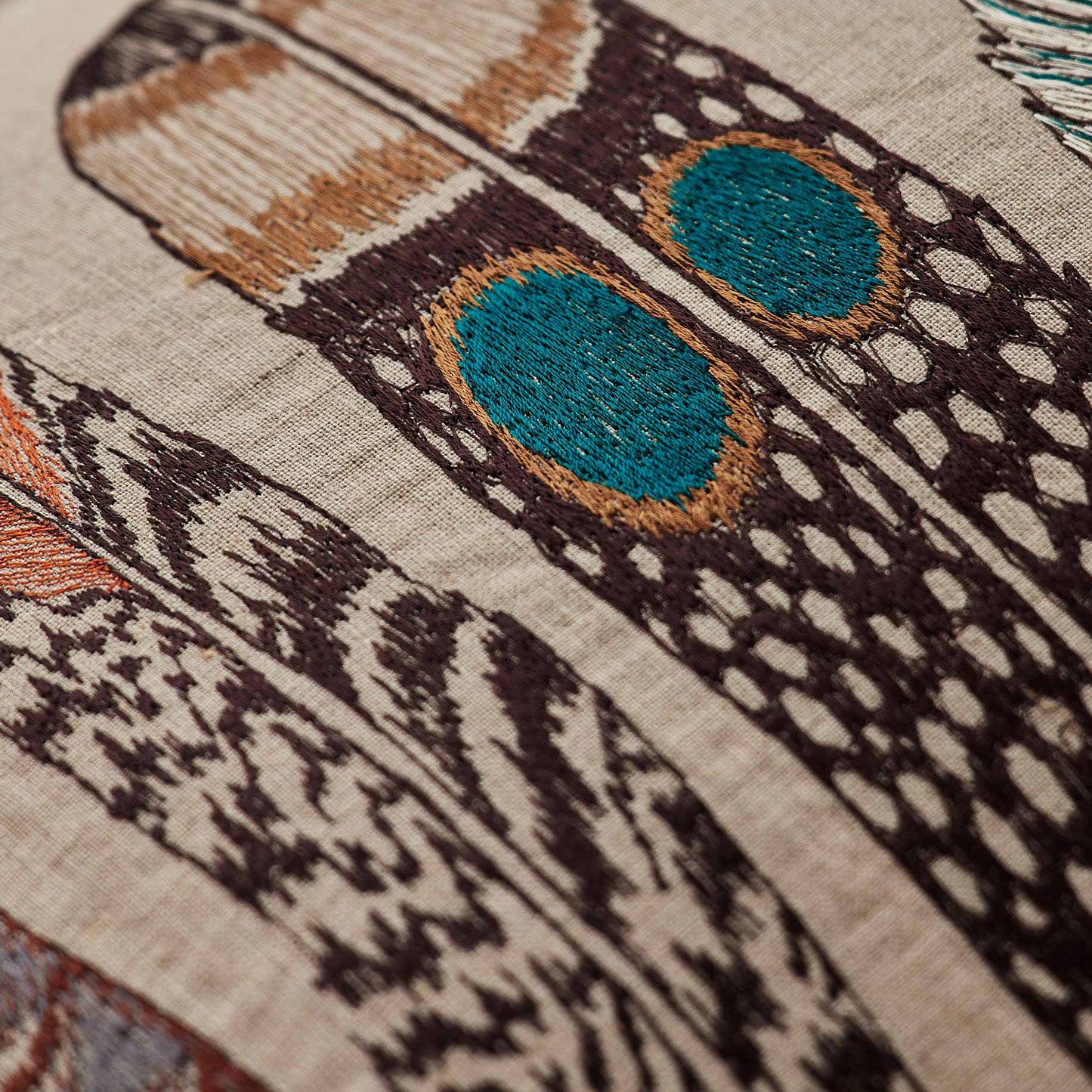 Coral and Tusk’s “Large Feathers” embroidered linen lumbar pillow featuring an array of feathers from birds of prey: hawk, eagle, falcon, and owl, measures 16” x 32”