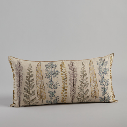 Coral and Tusk’s “Plants” embroidered linen lumbar pillow featuring a variety of plant stems in shades of green, measures 16” x 32”