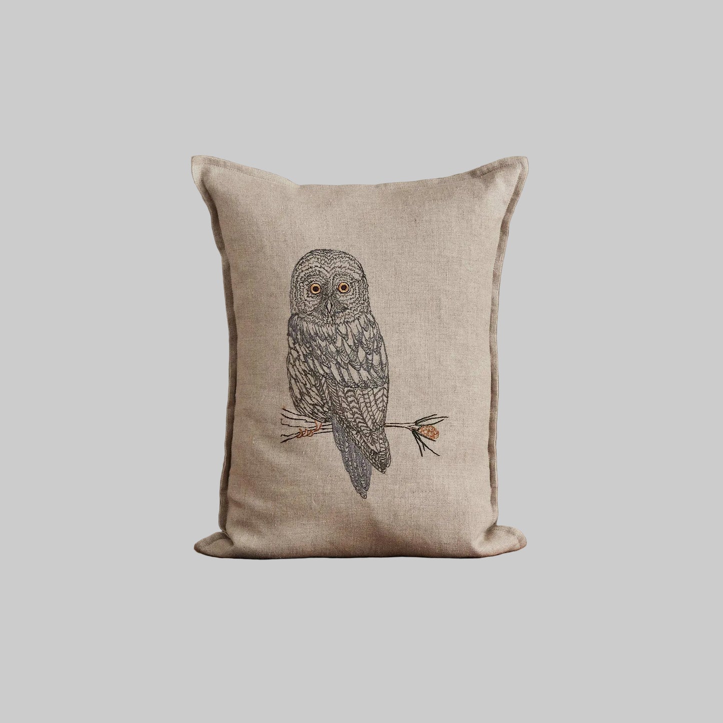 Coral and Tusk’s “Great Grey Owl” pillow featuring a wise owl with bright eyes and plumes of grey and silver, measures 12” x 16”