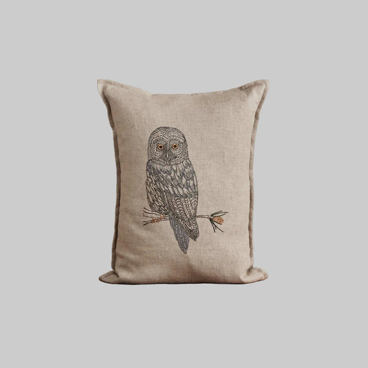 Coral and Tusk’s “Great Grey Owl” pillow featuring a wise owl with bright eyes and plumes of grey and silver, measures 12” x 16”