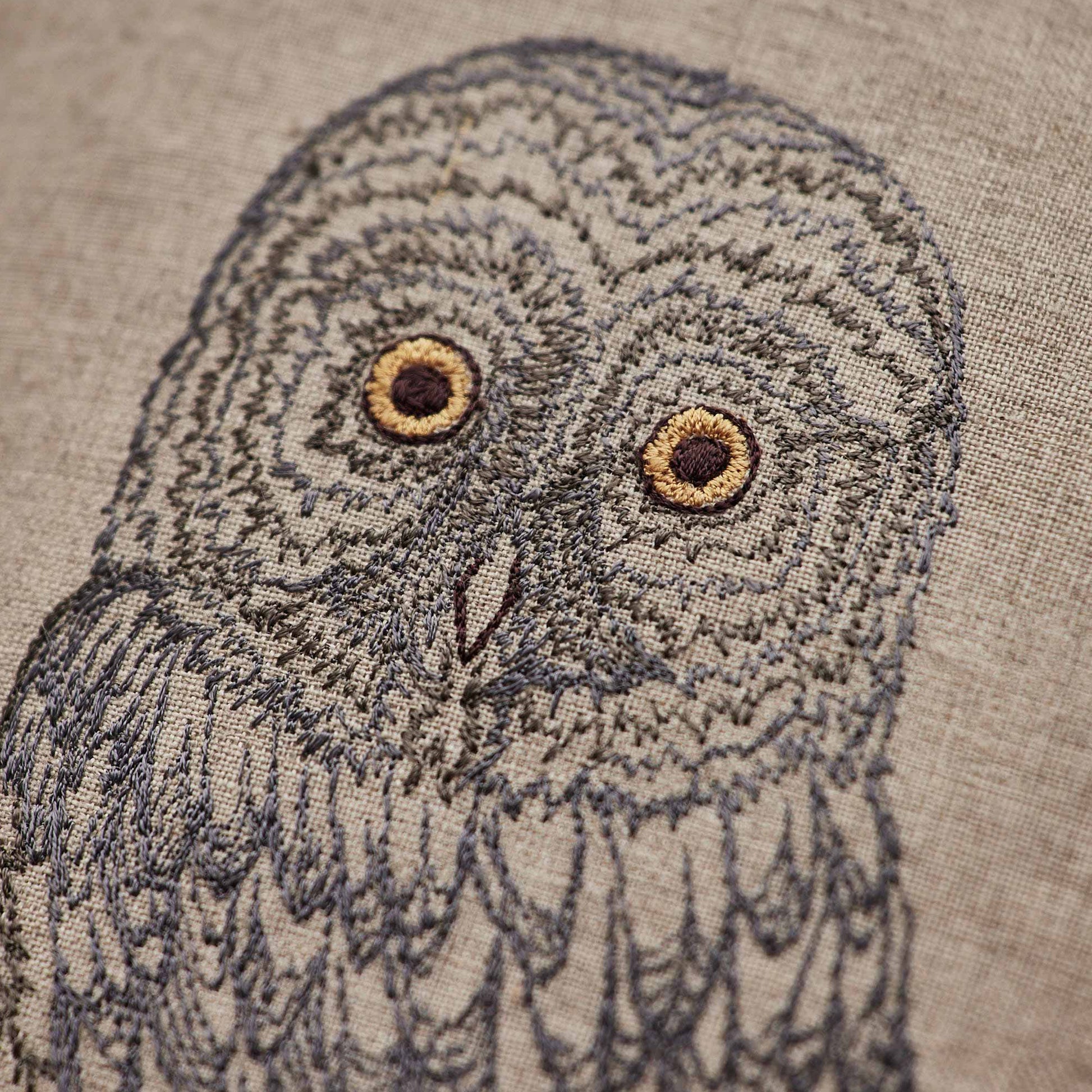 Coral and Tusk’s “Great Grey Owl” pillow featuring a wise owl with bright eyes and plumes of grey and silver, measures 12” x 16”