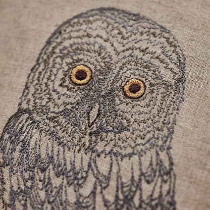 Coral and Tusk’s “Great Grey Owl” pillow featuring a wise owl with bright eyes and plumes of grey and silver, measures 12” x 16”