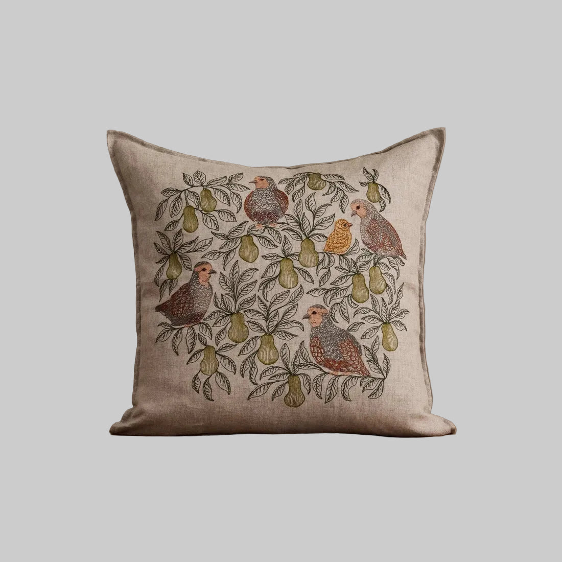 Coral and Tusk's "Partridge in A Pear Tree" embroidered linen pillow featuring a design of four partridges plus a chick perched in pear tree branches