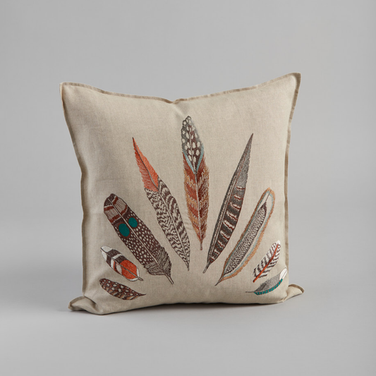 Coral and Tusk's "Plumes Fan" embroidered linen pillow featuring a vivid array of feathers from hawks, pheasants, owls, orioles, and jays, measures 20" x 20"