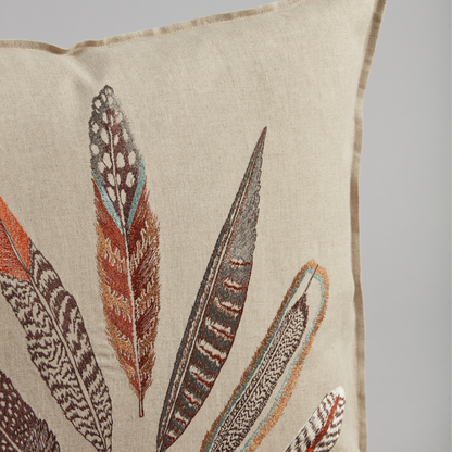 Coral and Tusk's "Plumes Fan" embroidered linen pillow featuring a vivid array of feathers from hawks, pheasants, owls, orioles, and jays, measures 20" x 20"