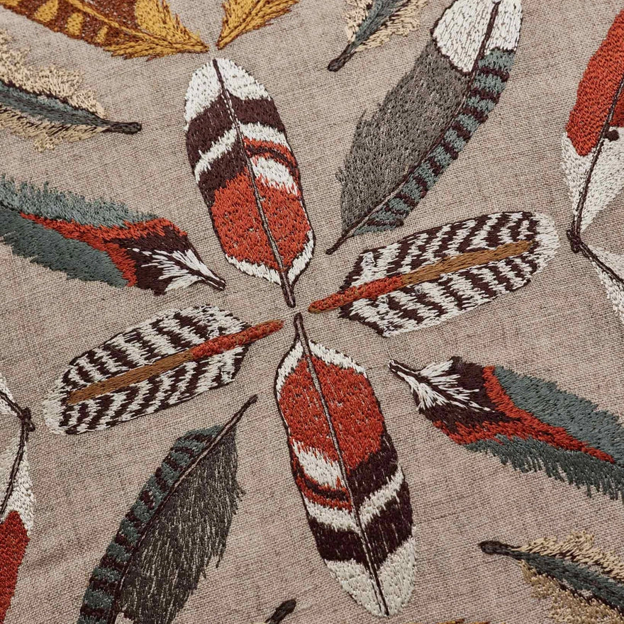 Coral and Tusk's embroidered linen "Feather Radiance" pillow designs of patterned bird feathers