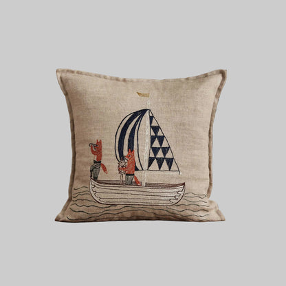 Coral and Tusk’s “Sailing Foxes” embroidered linen pillow featuring two foxes on a sailboat, measures 12” x 12”