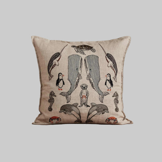 Coral and Tusk’s “Sea Friends” embroidered linen pillow featuring a variety of marine life found in oceans across the world, measures 16” x 16”