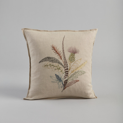 Coral and Tusk's "Thistle" embroidered linen pillow featuring a bouquet of gathered thistles, greenery and feathers, measures 16" x 16"