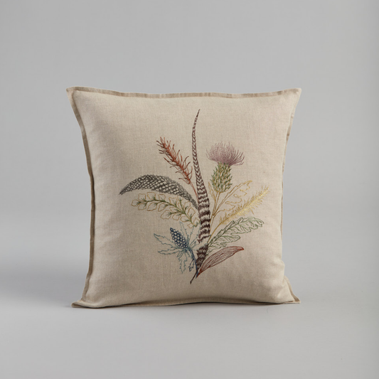 Coral and Tusk's "Thistle" embroidered linen pillow featuring a bouquet of gathered thistles, greenery and feathers, measures 16" x 16"