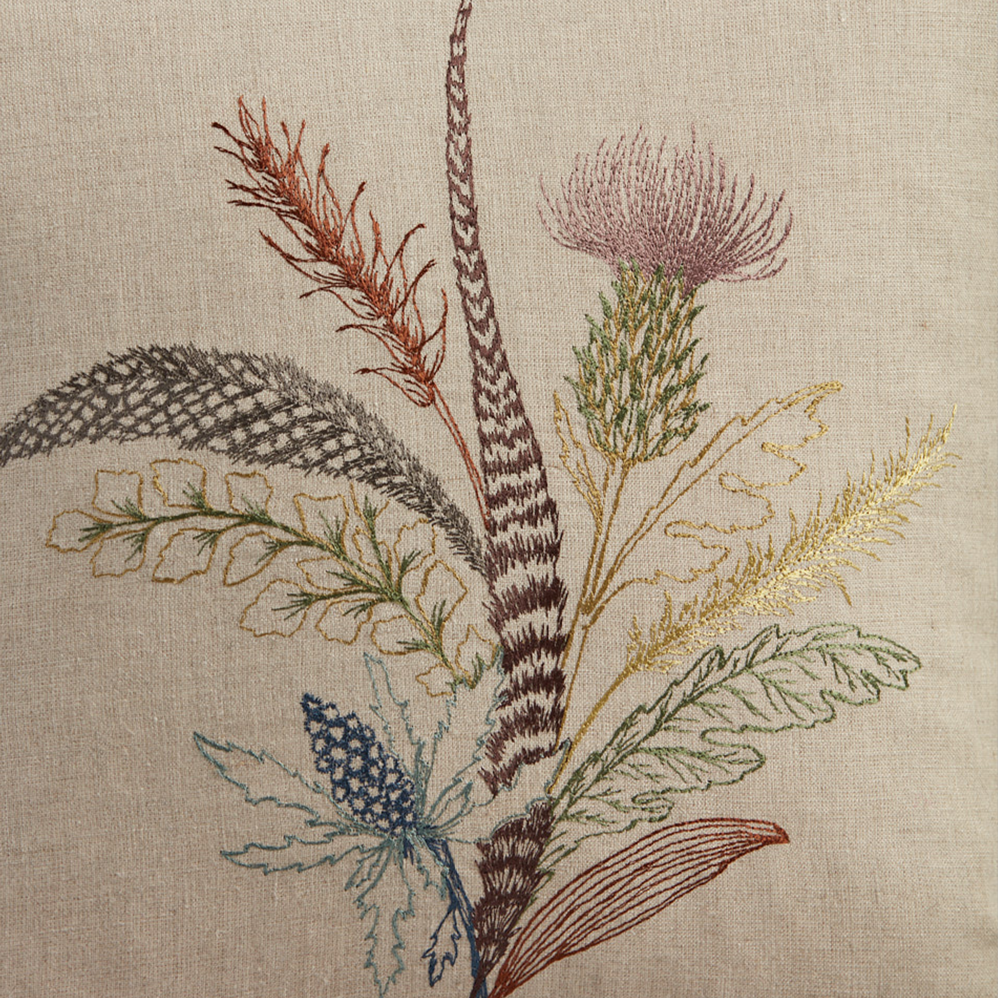 Coral and Tusk's "Thistle" embroidered linen pillow featuring a bouquet of gathered thistles, greenery and feathers, measures 16" x 16"