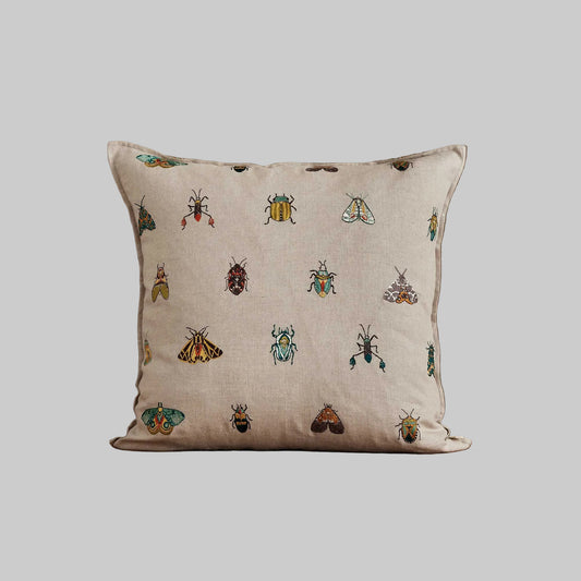 Coral and Tusk’s “Wings Pattern” embroidered linen pillow featuring vibrantly embellished beetles and moths, measures 20” x 20”
