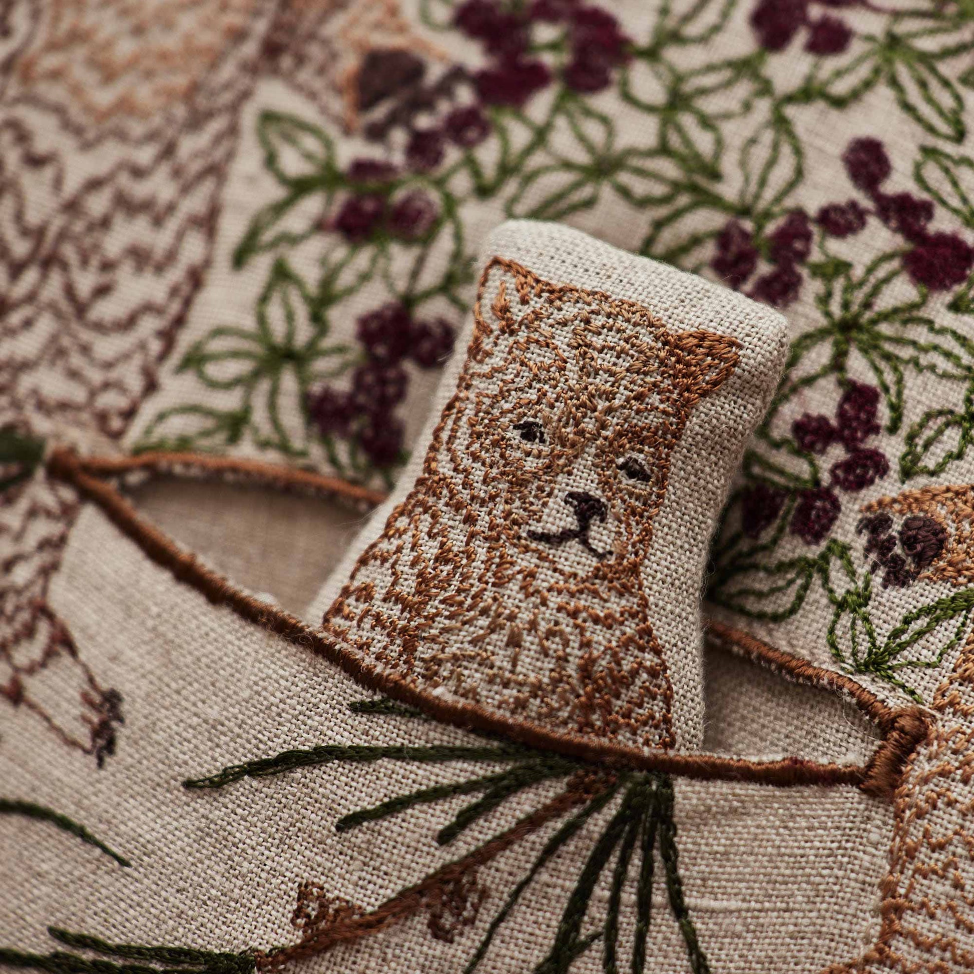 Coral and Tusk’s “Briar Bears” pocket pillow featuring a family of brown bears snacking on blackberries, measures 12” x 16”
