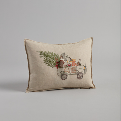 Coral and Tusk's "Christmas Tree Car" embroidered linen pocket pillow featuring woodland animals riding in a car with their Christmas tree, measures 12" x 16"