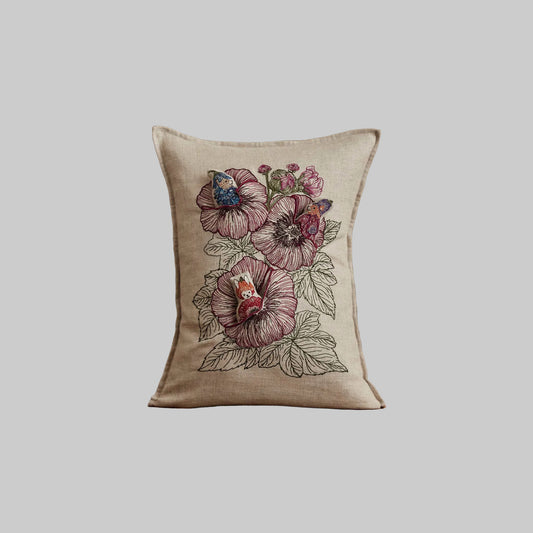 Coral and Tusk’s “Fairy Bloom” embroidered linen pocket pillow featuring three animal fairies hiding among some spring flowers, measures 12” x 16”