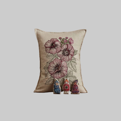 Coral and Tusk’s “Fairy Bloom” embroidered linen pocket pillow featuring three animal fairies hiding among some spring flowers, measures 12” x 16”