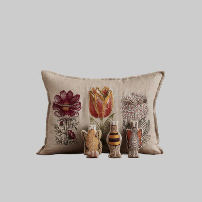 Coral and Tusk’s “Flower Friends” embroidered linen pocket pillow featuring the first flowers of spring with some animal friends hidden in their petals, measures 12” x 16”