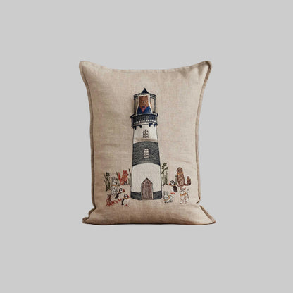 Coral and Tusk’s “Lighthouse Friends embroidered linen pocket pillow featuring a lighthouse keeper bear lighting the way for his nautical friends, measures 12” x 16”