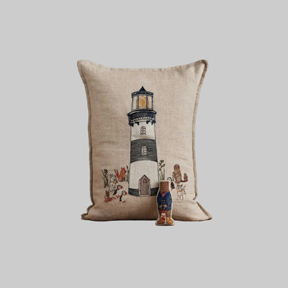 Coral and Tusk’s “Lighthouse Friends embroidered linen pocket pillow featuring a lighthouse keeper bear lighting the way for his nautical friends, measures 12” x 16”