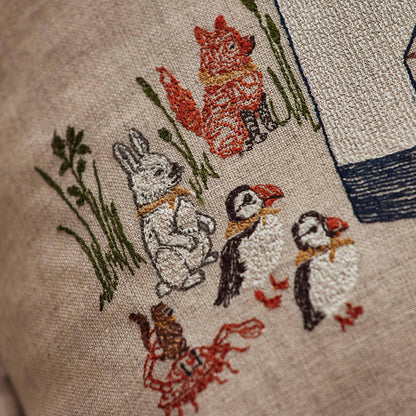 Coral and Tusk’s “Lighthouse Friends embroidered linen pocket pillow featuring a lighthouse keeper bear lighting the way for his nautical friends, measures 12” x 16”