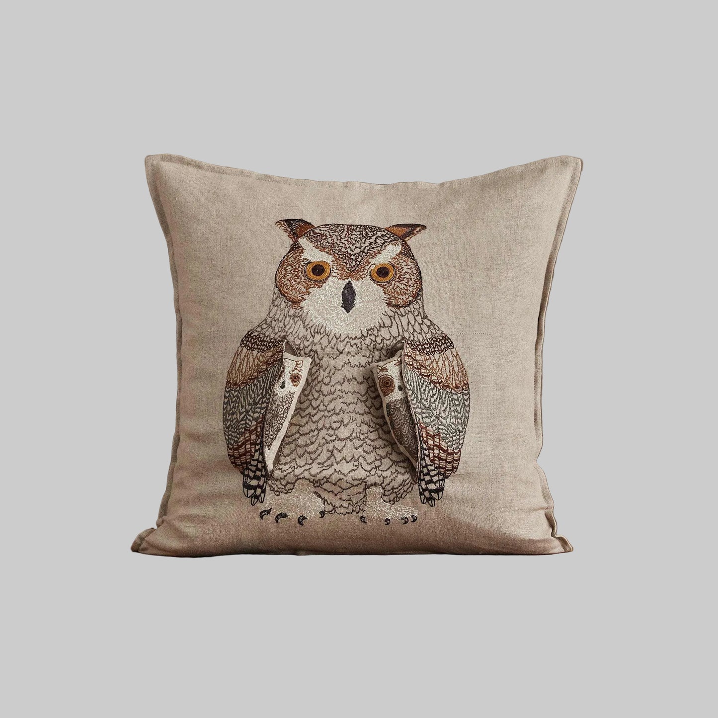 Coral and Tusk’s “Owl Mama” embroidered linen pocket pillow featuring a mother owl with removable owlets under each wing, measures 16” x 16”