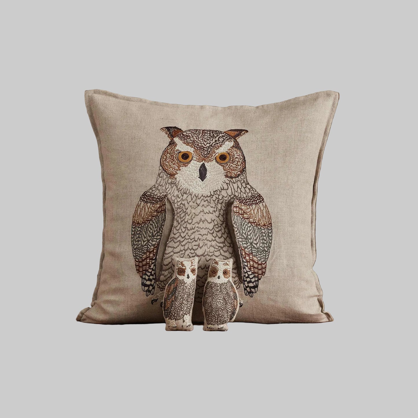 Coral and Tusk’s “Owl Mama” embroidered linen pocket pillow featuring a mother owl with removable owlets under each wing, measures 16” x 16”