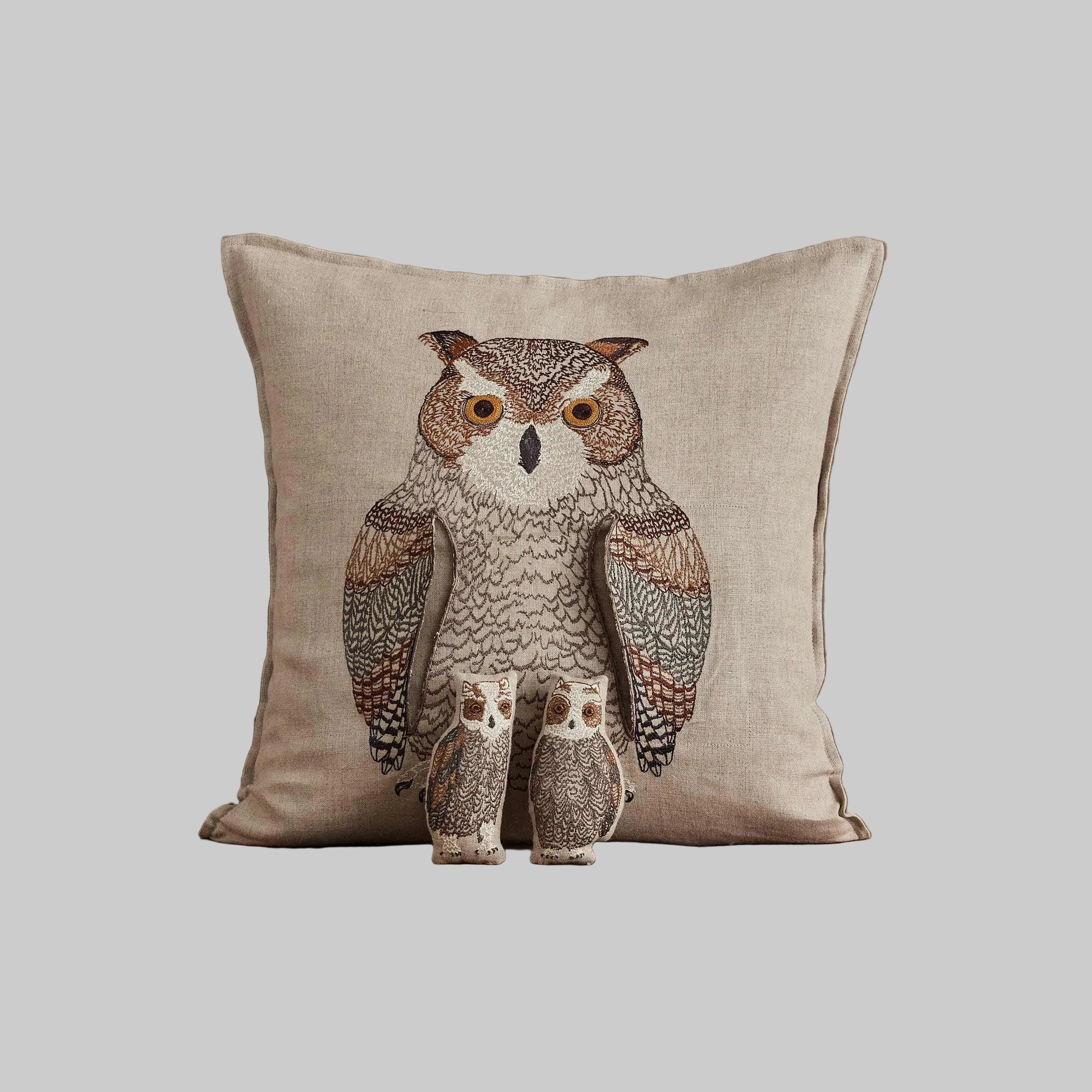 Coral and Tusk’s “Owl Mama” embroidered linen pocket pillow featuring a mother owl with removable owlets under each wing, measures 16” x 16”